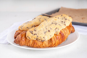 Trendy French sweet dessert pastry crookie, a hybrid of croissant with sweet butter cookies with...