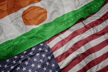 waving colorful flag of united states of america and national flag of niger on the dollar money...