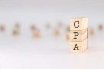 CPA acronym. Concept of Certified Public Accountant written on wooden cubes isolated on white background.