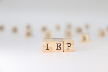 IEP Acronym. Concept of Individual Education Plan written on wooden cubes isolated on white background.