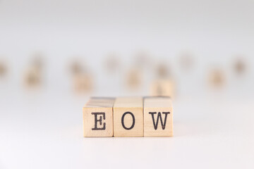 Abbreviation EOW. Concept for End Of Week written on wooden cubes isoated on white background.