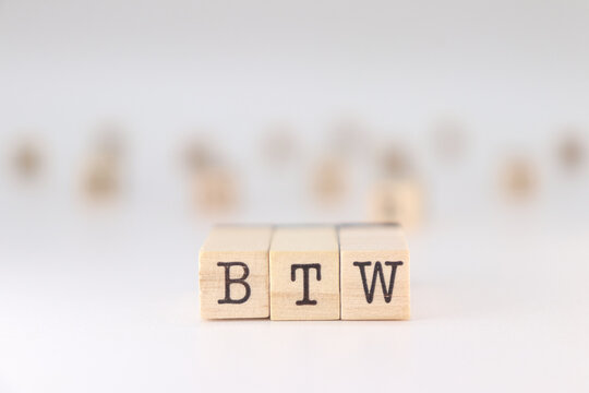 BTW acronym. Concept of by the way written on wooden cubes isolated on white background.