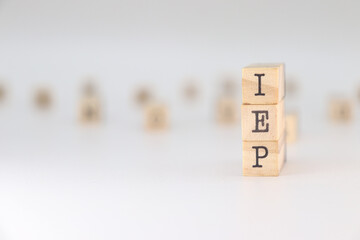 IEP Acronym. Concept of Individual Education Plan written on wooden cubes isolated on white background.