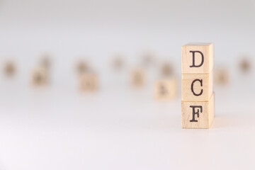 DCF acronym. Concept of Discounted Cash Flow written on wooden cubes isolated on white backround.