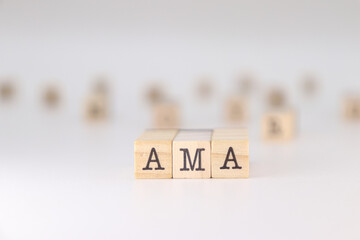 AMA word. Concept of ask me anything written on wooden cubes isolated on white background.