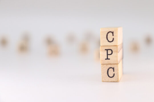 CPC Acronym. Concept of Cost Per Click written on wooden cubes isolated on white background.