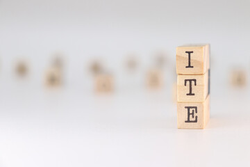 Word ITE written on wooden cubes isolated on white background . Concept of Technical Inspection of Buildings on spain