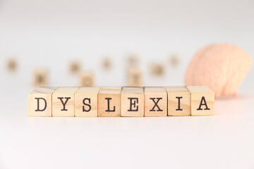 Word dyslexia written on wooden cubes isolated on white background. Concept of mental health