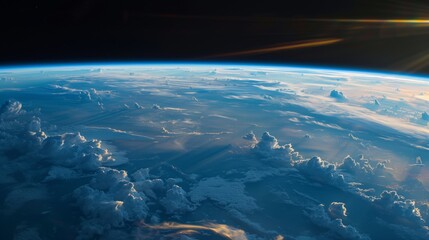 Stunning view of Earth's atmosphere from space showing cloud formations and a sunrise horizon.