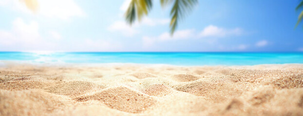 Beautiful wide panorama of a paradise beach with golden sand and palm leaves in blur. Summer banner.