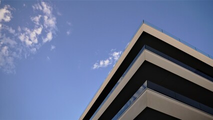 contemporary building corner facade against cloudy sky