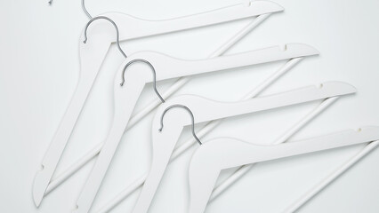 Creative flat lay hangers white background. Sale discount store promo shopping concept. Top view. Copy space