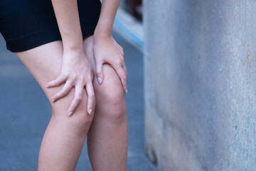 Asian woman having knee osteoarthritis joint pain or knee injury problem, concept of injured leg,...