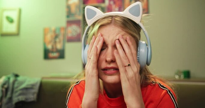 Gamer, frustrated and lose with competition, esports and stress or mistake. Woman, rage and technology with neon, lounge and apartment or home living room with console and video game for play