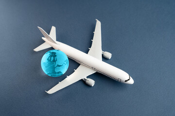 Airplane and blue globe. Construction of new airfields. Development of civil aviation. Travel and...