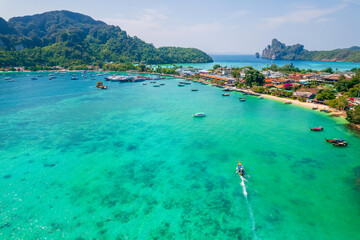 longtail boat turquoise clear water in Phi Phi, Krabi Thailand. Amazing travel landscape photo in...