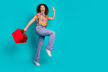 Photo of charming cheerful woman wear stylish print clothes hurry store market empty space isolated on cyan color background