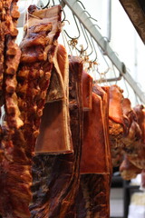 dry aged meat hanging in a market