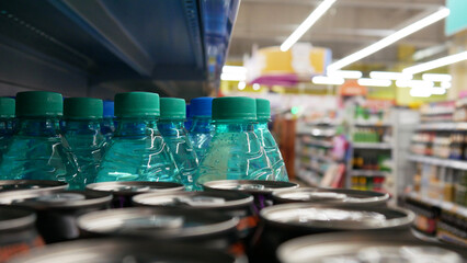 Close-up of many blue plastic bottles with mineral water in a supermarket