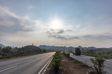 Landscape of Indian national highways surrounded by aravalli hills under the blue sky. National highways connected different cities and also saves time and fuel.