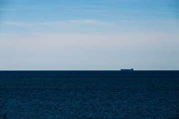 Large bulk carrier ship on the horizon.