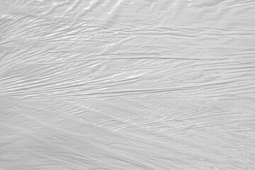 white packaging film with folds and wrinkles, abstract background