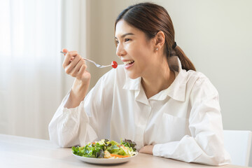 Diet concept, happy smile asian young woman use fork to prick tomato, fresh vegetable or green...