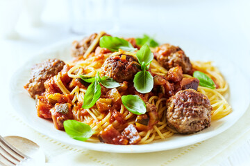 Spaghetti Pasta with Meatballs and fresh Basil o bright background. Close up.	