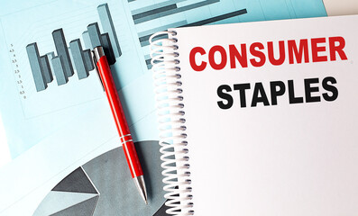 CONSUMER STAPLES text on notebook on chart background