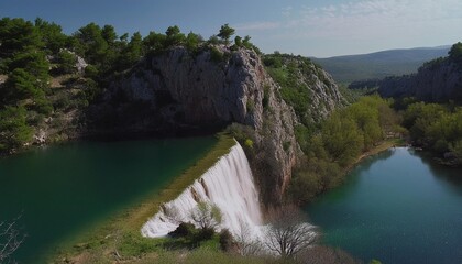 converging edge of landform with water streaming over edge into pond below in croatia - obrazy, fototapety, plakaty