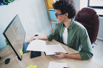 Photo of cool smart employee wear khaki shirt eyeglasses signing contract modern device indoors...