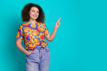 Photo of cheerful lovely woman wear stylish print clothes look empty space isolated on cyan color...