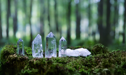 set of Crystal minerals towers in forest, natural background. Clear quartz for Magic Crystal...