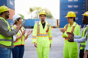 Coworkers clapping hands to engineer or worker for success work or project in containers warehouse storage