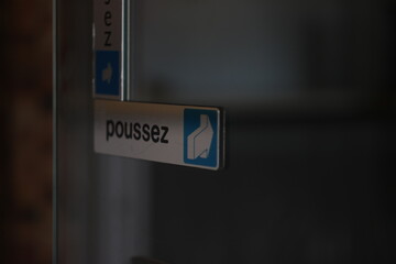 entrance sign in french on glass door