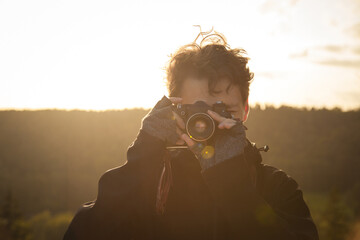 Young man with retro camera