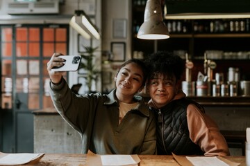 Daughter taking selfie with mum