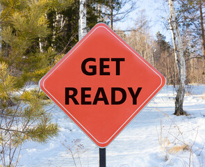 Get ready symbol. Concept words Get ready on beautiful red road sign. Beautiful forest snow blue sky background. Business, support, motivation and get ready concept. Copy space.