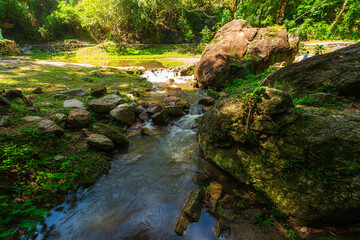 Obraz premium Huai Kaeo waterfall at Huai Kaeo waterfall National Park in tourist attraction with green forest nature in Chiang Mai,Thailand.
