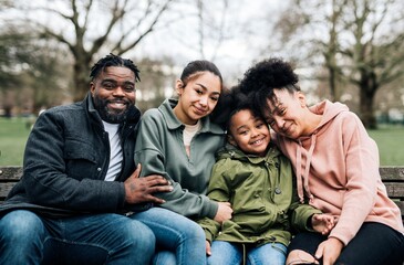 Happy African-American family sitting in a park