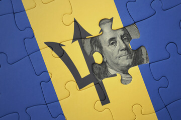 puzzle with the national flag of barbados and usa dollar banknote. finance concept