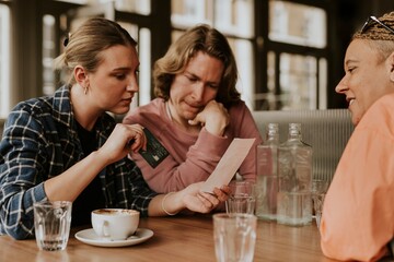 Friends looking at the bill