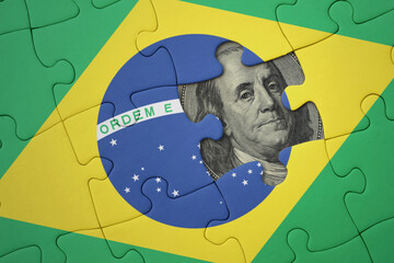 puzzle with the national flag of brazil and usa dollar banknote. finance concept