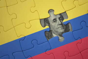 puzzle with the national flag of colombia and usa dollar banknote. finance concept