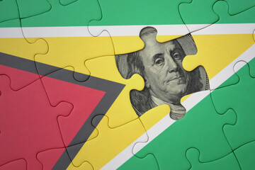 puzzle with the national flag of guyana and usa dollar banknote. finance concept