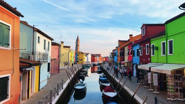 Burano View: Colorful houses, canals and waterways in Italy's timeless city where gondolas glide beneath arched bridges in a historic city that floats on romance
