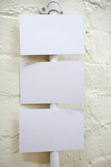 An empty blank paper table card name plate sign on a wall, empty note, shot with a shallow depth of field. perfect for placing names in composite designs.