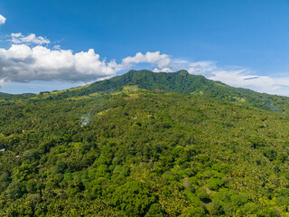 Obraz premium Greenery mountain with lush greenery forest and jungle. Blue sky and clouds. Camiguin Island. Philippines.