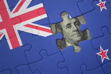 puzzle with the national flag of new zealand and usa dollar banknote. finance concept