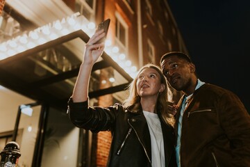 Couple taking selfies, date night photo